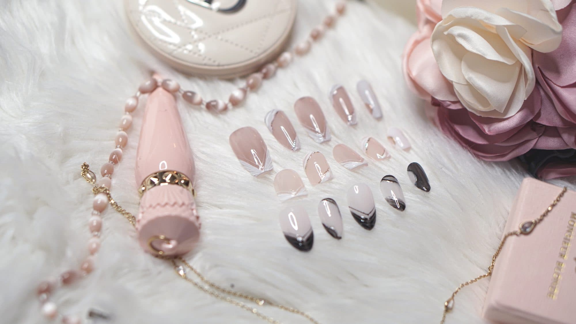 Two handcrafted Nails by Shimmyhands sets styled with florals